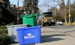 Trash truck and recycling bins on the curb