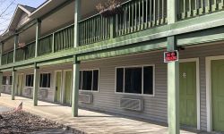 A closed green-colored motel. 