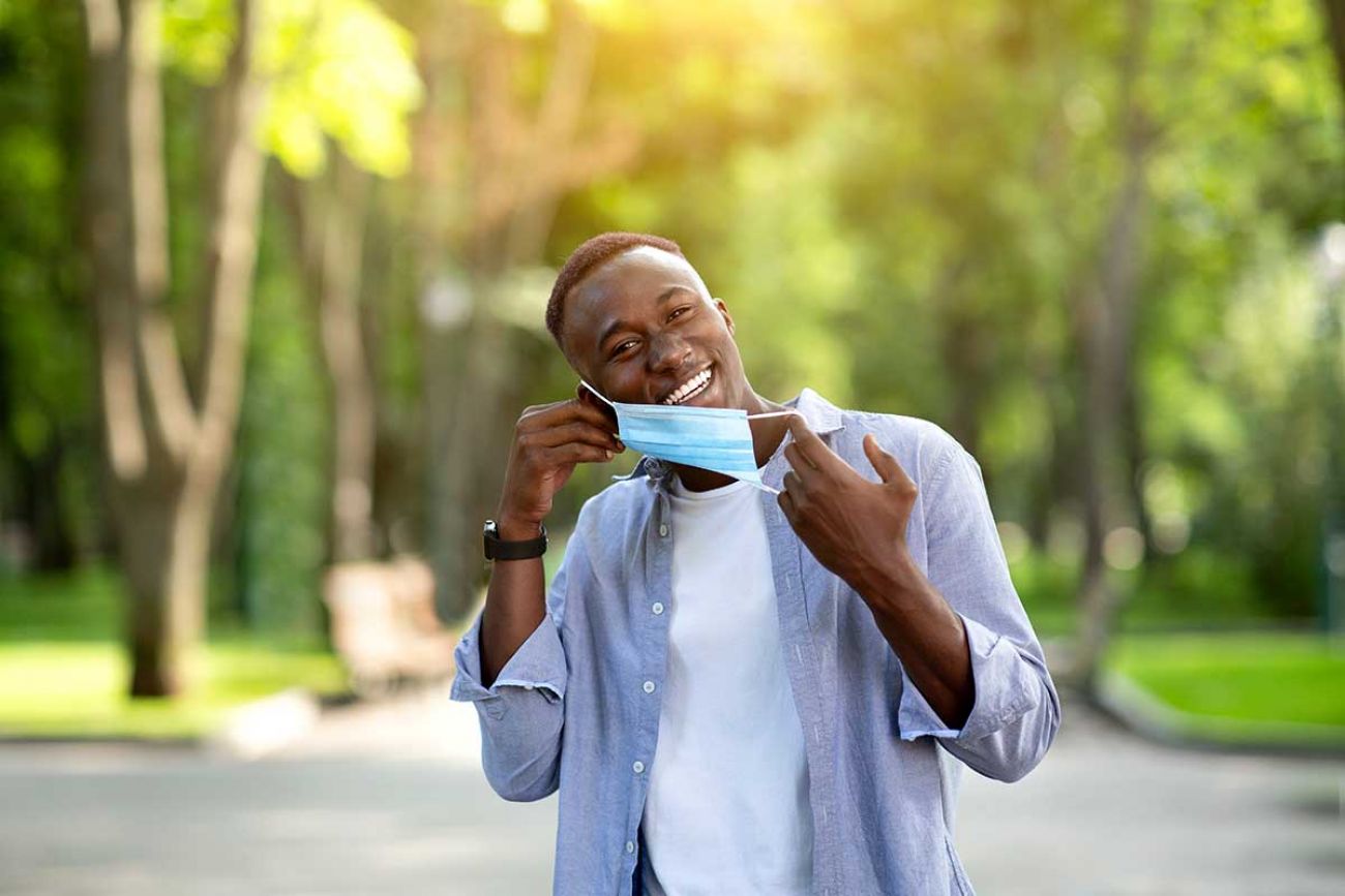 man removing mask