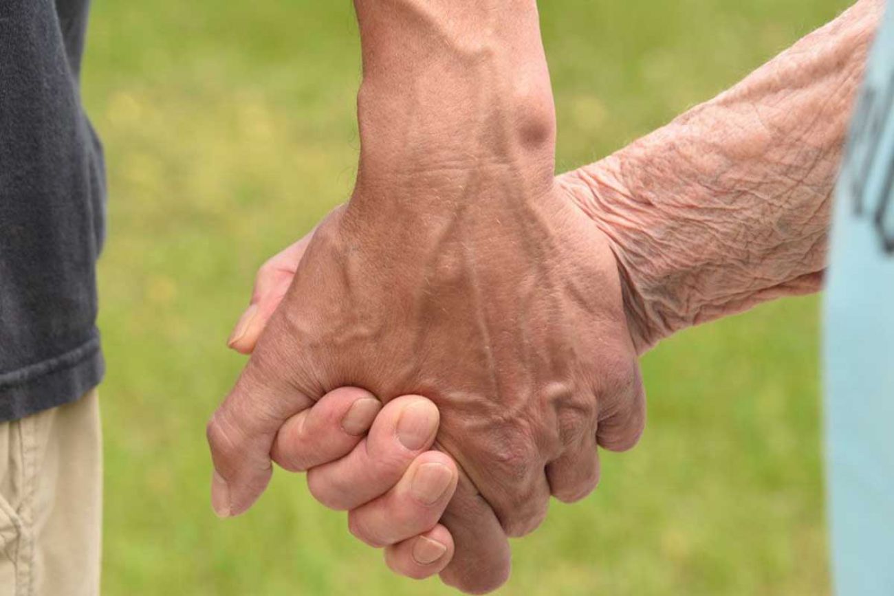 Eric Dolson, who is shown here grasping the hand of his mother, Lorli Marie Dolson