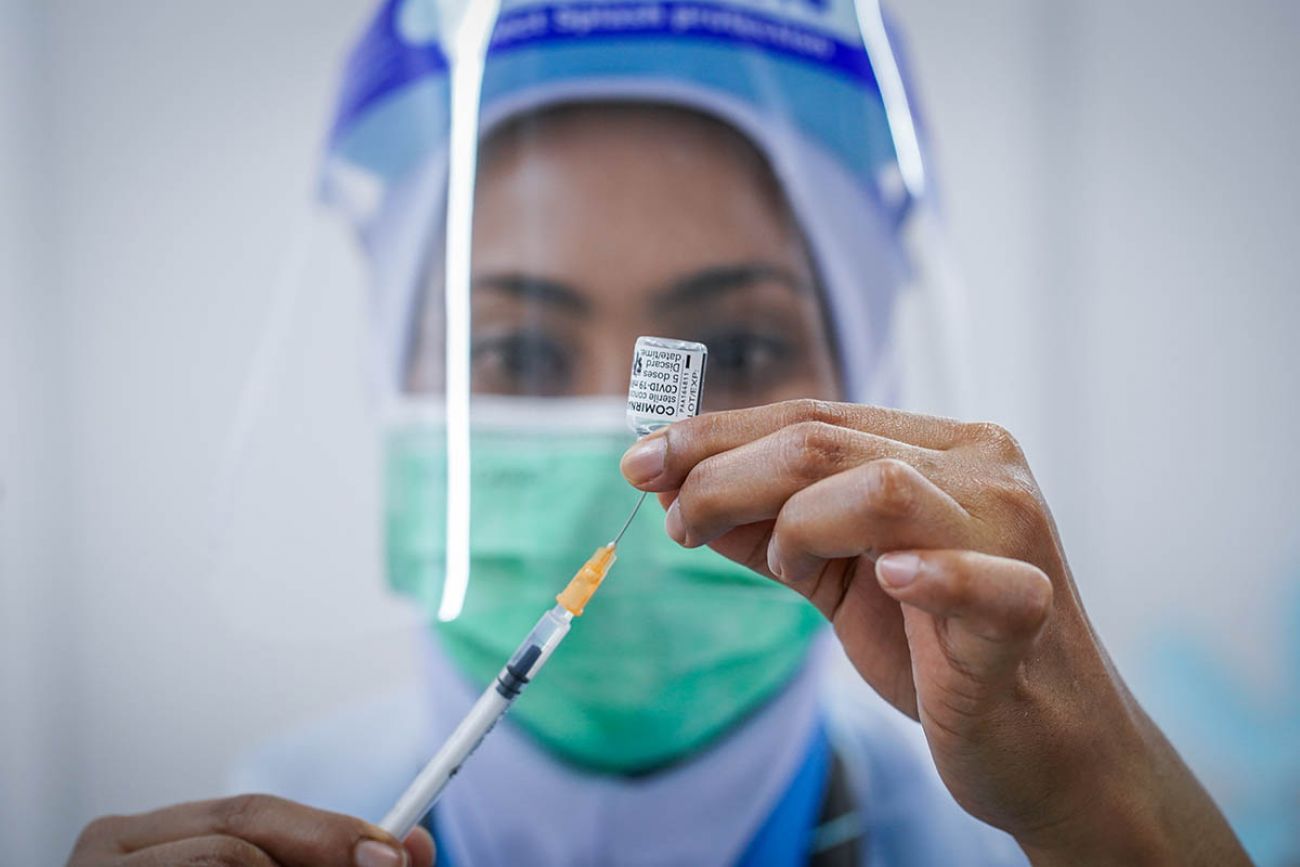 person holding vaccine