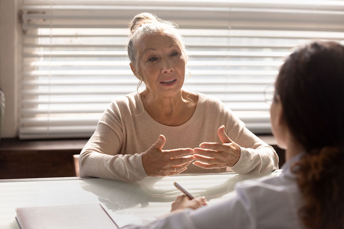 older woman on a desk