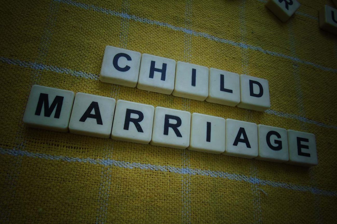 Child Marriage, word cube with background.