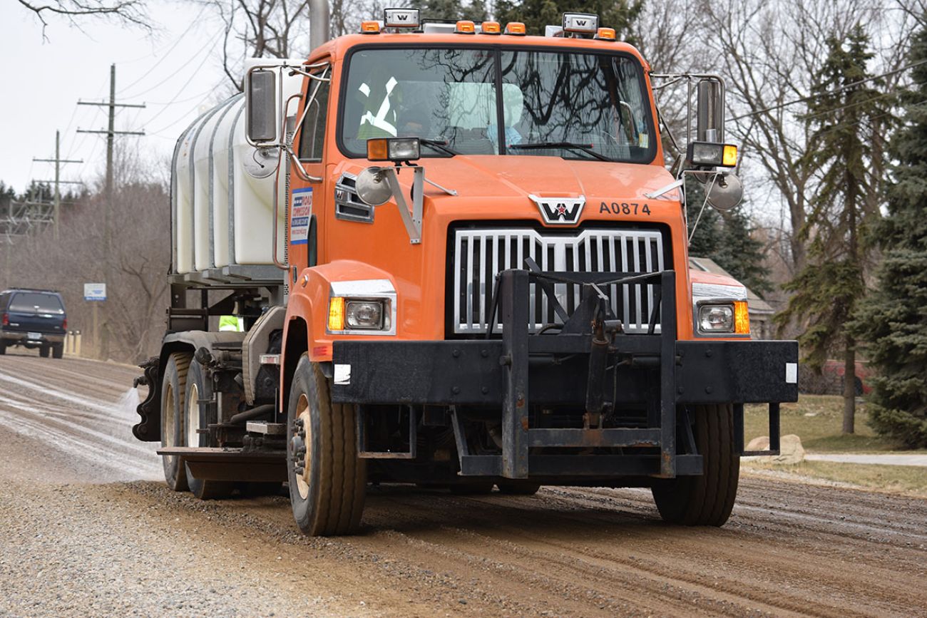 truck spraying brine on the road