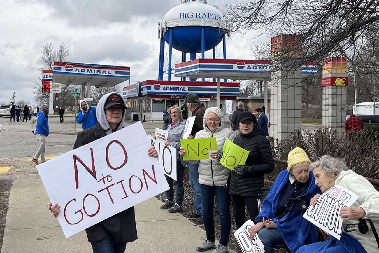 people holding signs saying "No to Gotion" 