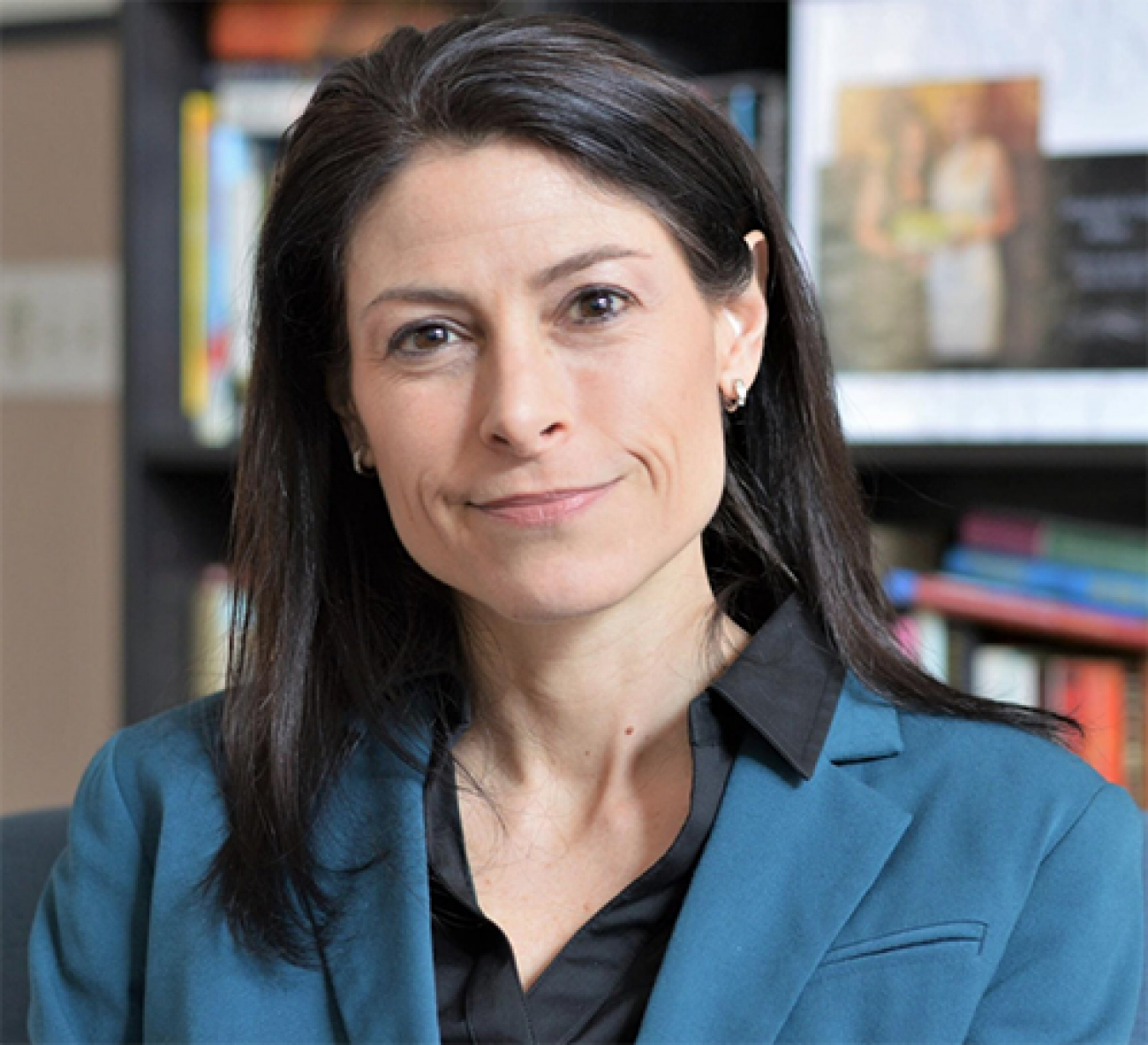 Michigan Attorney General Dana Nessel with bookshelf in background