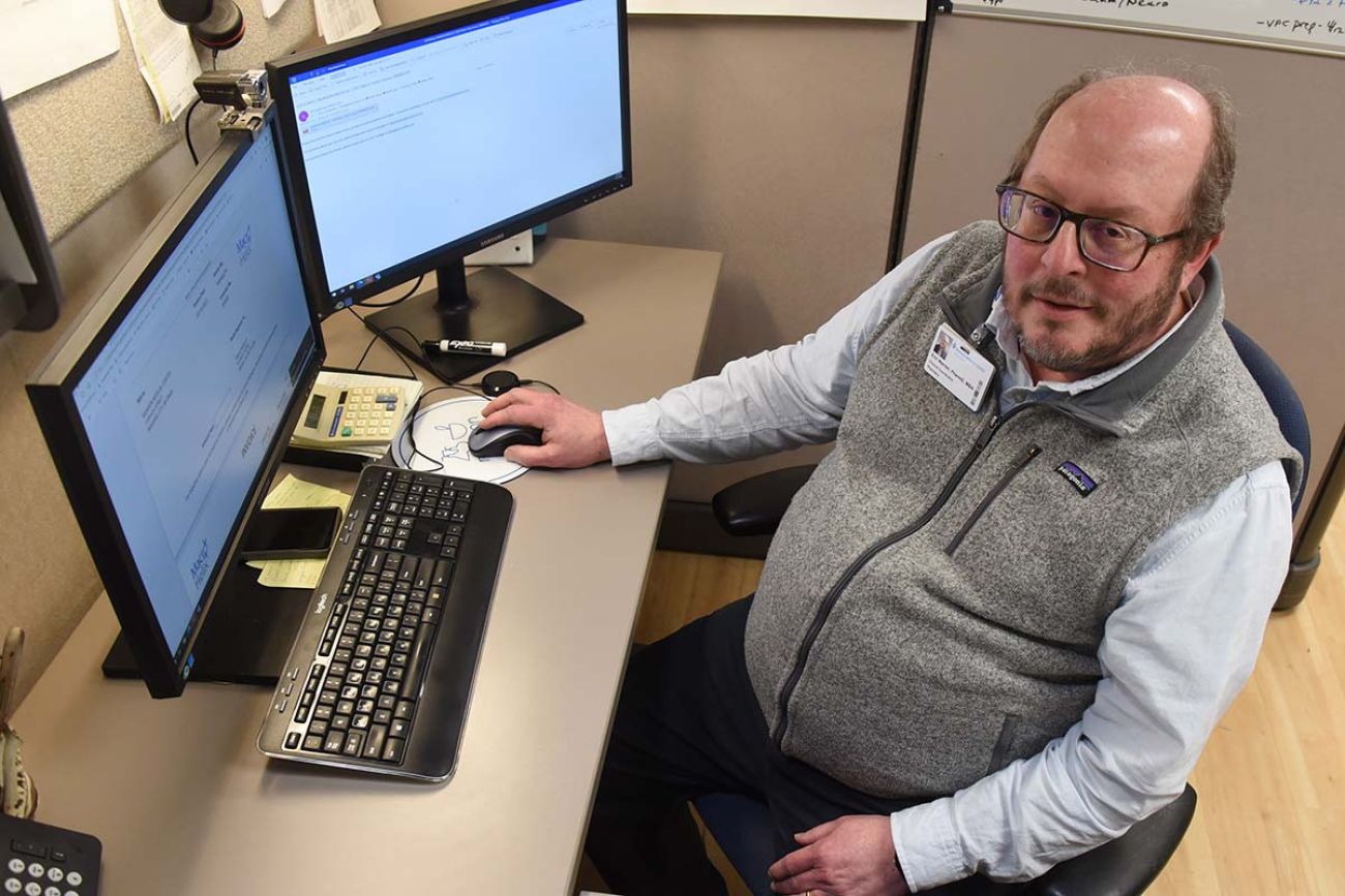 man sitting at computer