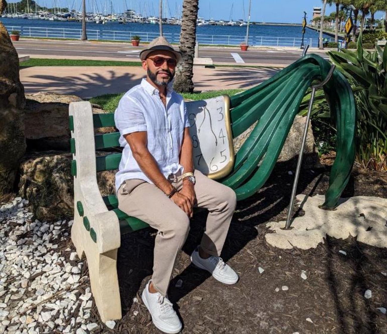 Farhan Malik sitting down on a bench 