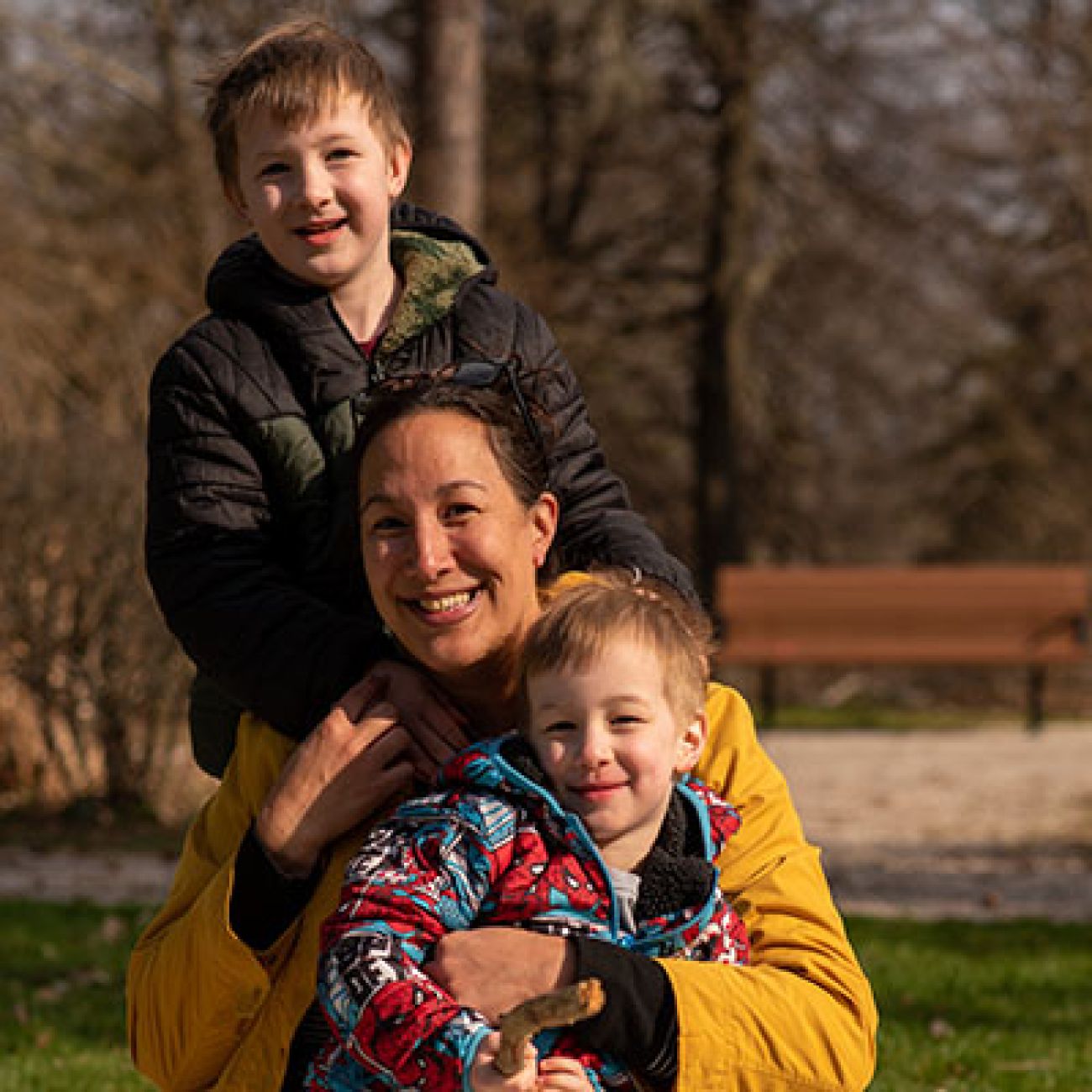 Jennifer with her two sons posing for a picture outside