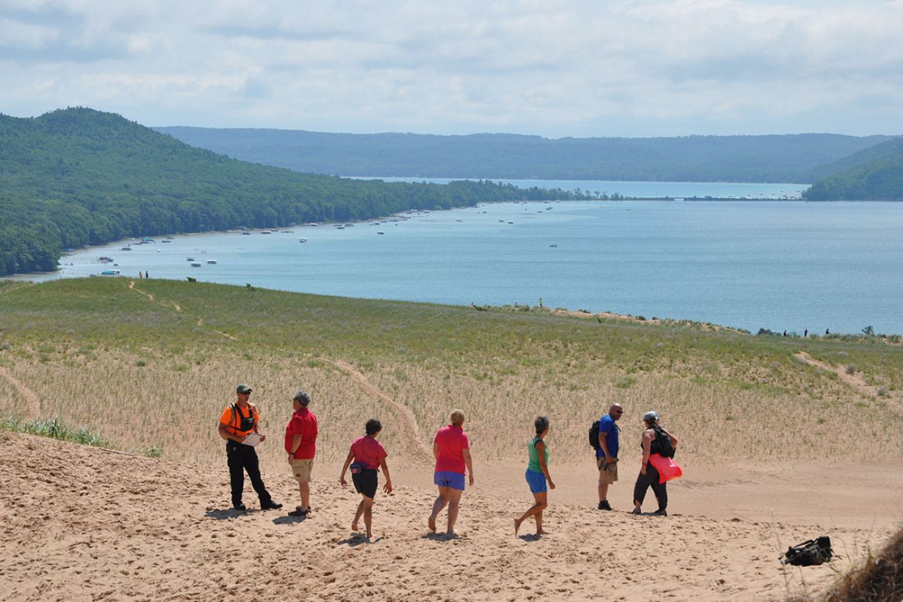 people walking on Sleeping Bear Dunes