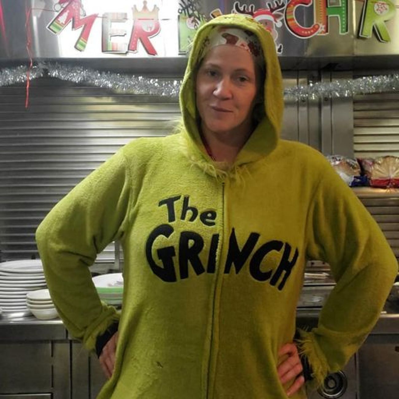 woman wearing a grinch sweatshirt