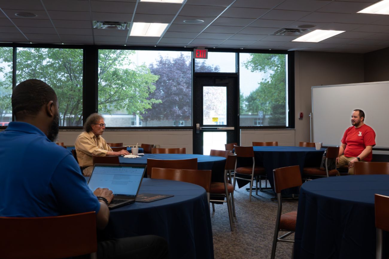 Wegela sits with constituents.