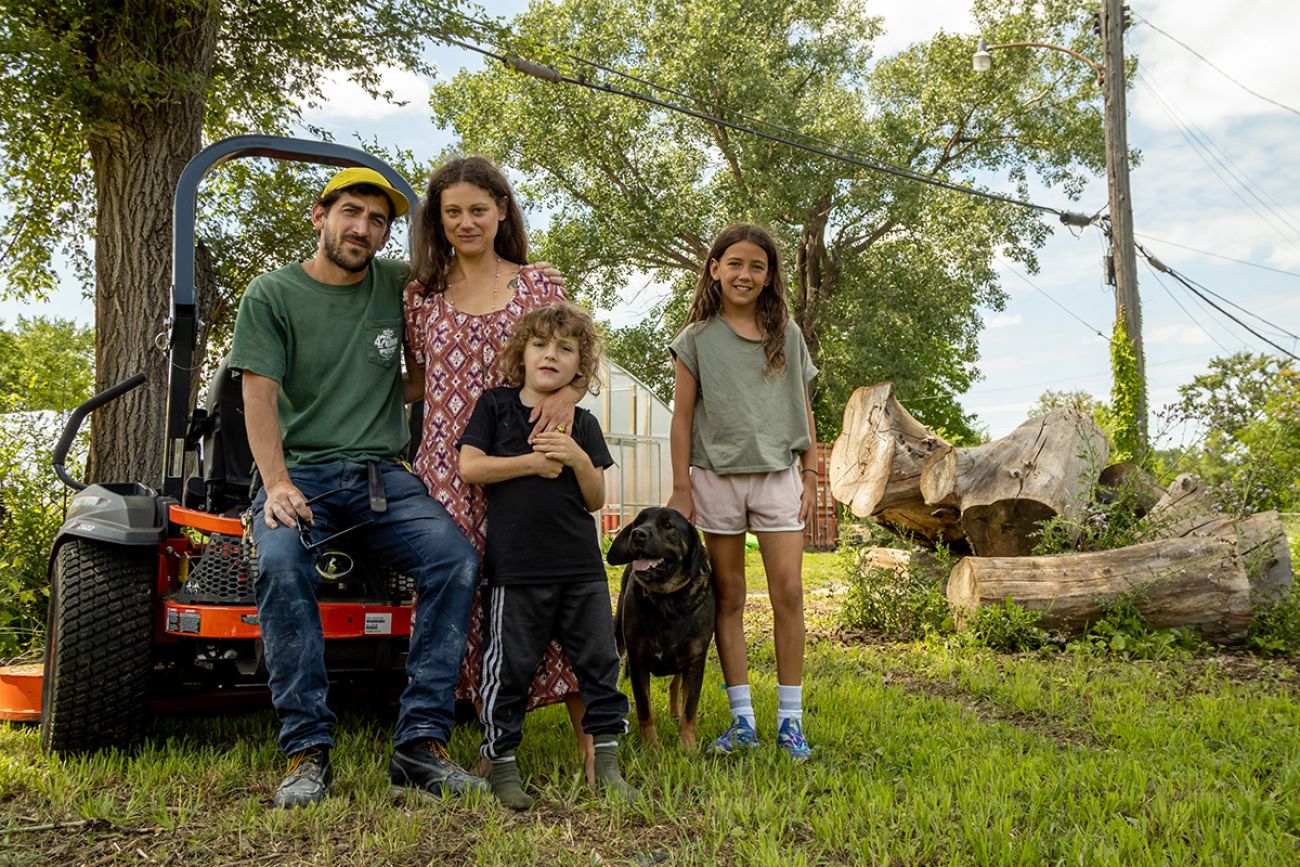 family posing for a picture outside