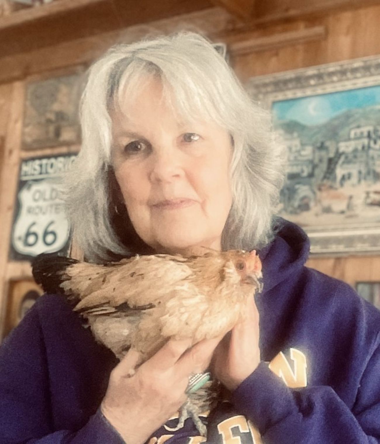 Marsi Darwin holding Peanut, the world’s oldest chicken