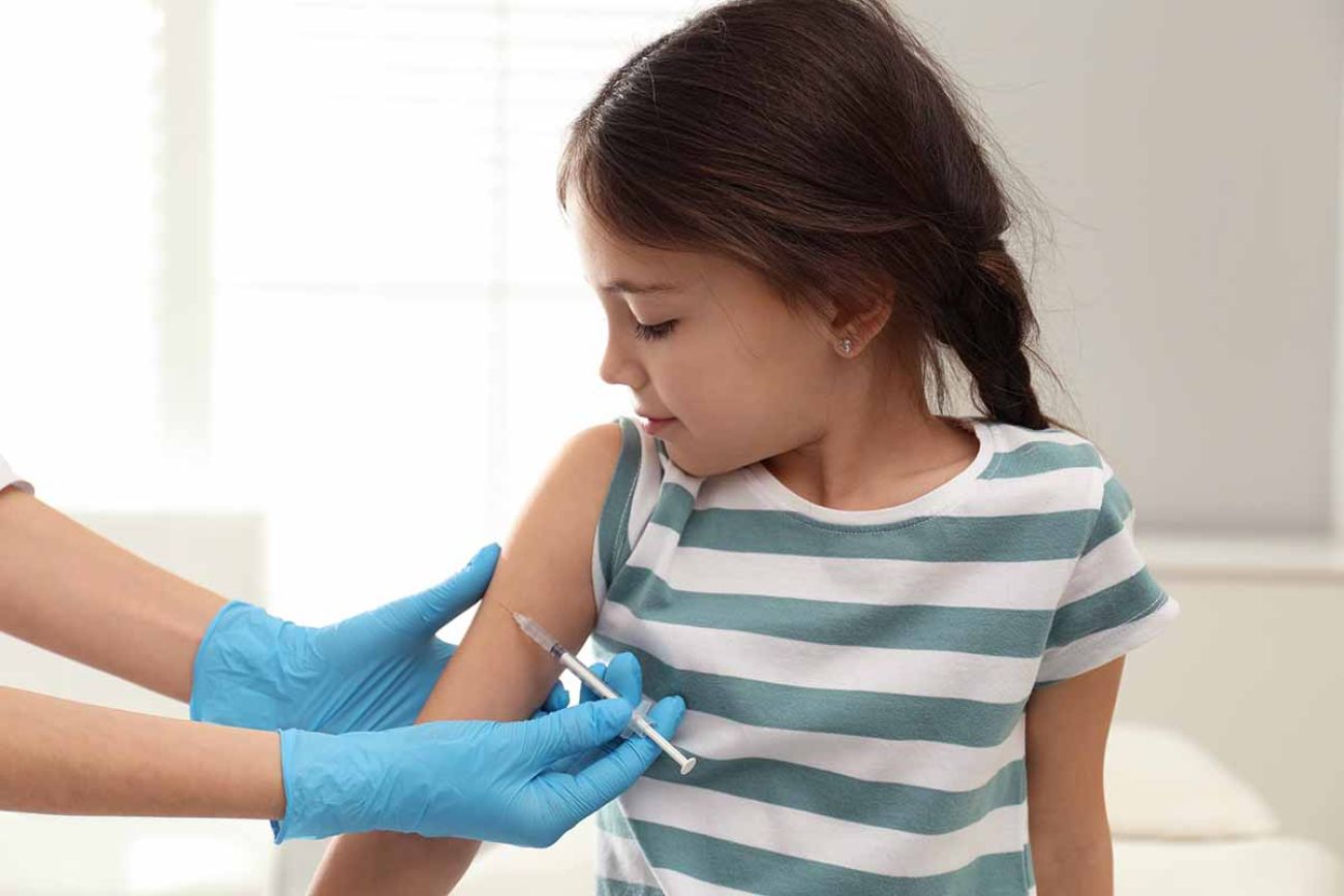 Doctor vaccinating little child in modern clinic