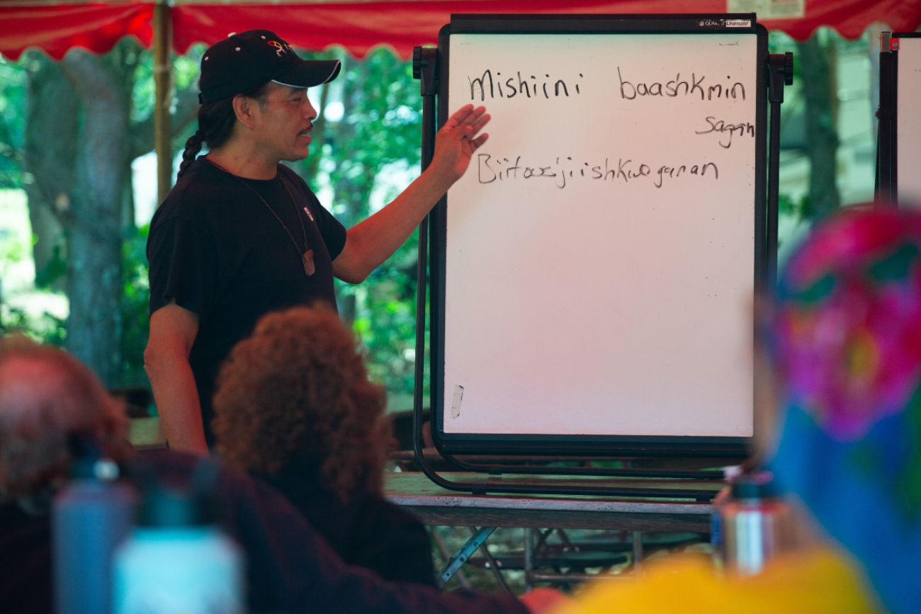 Man stands in front of white board