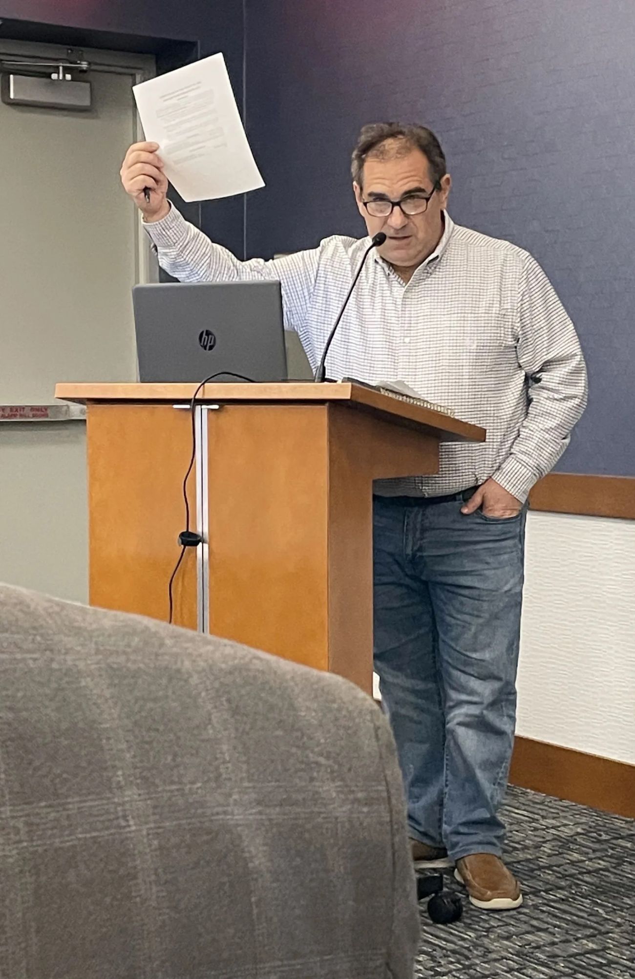 man holding paper above his head