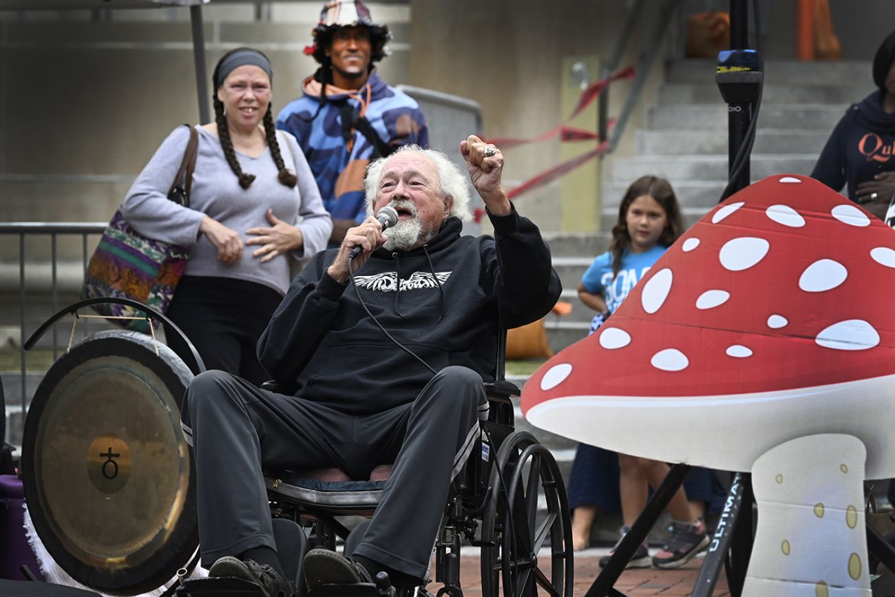 John Sinclair speaks in a microphone