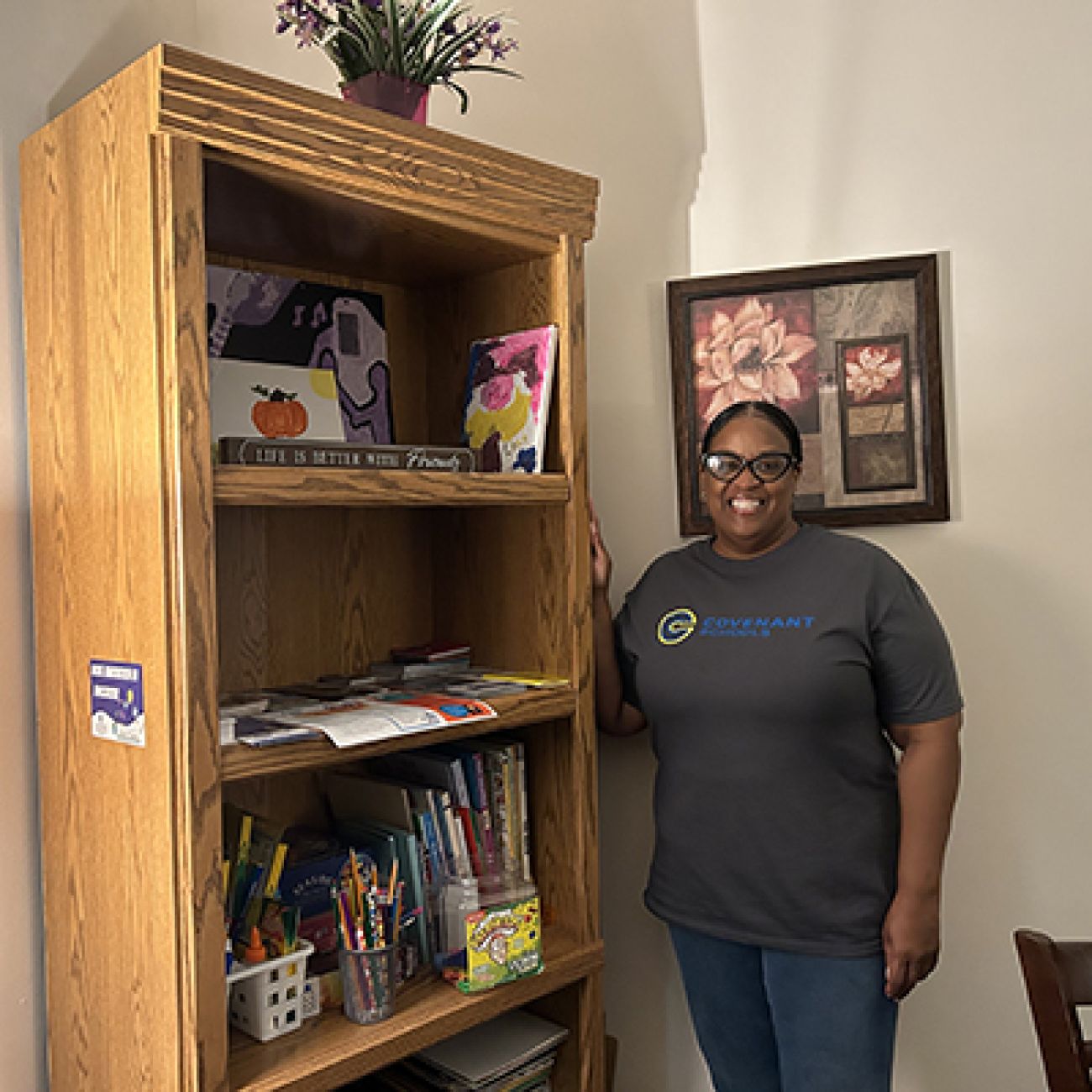 woman standing next to a bookshelf