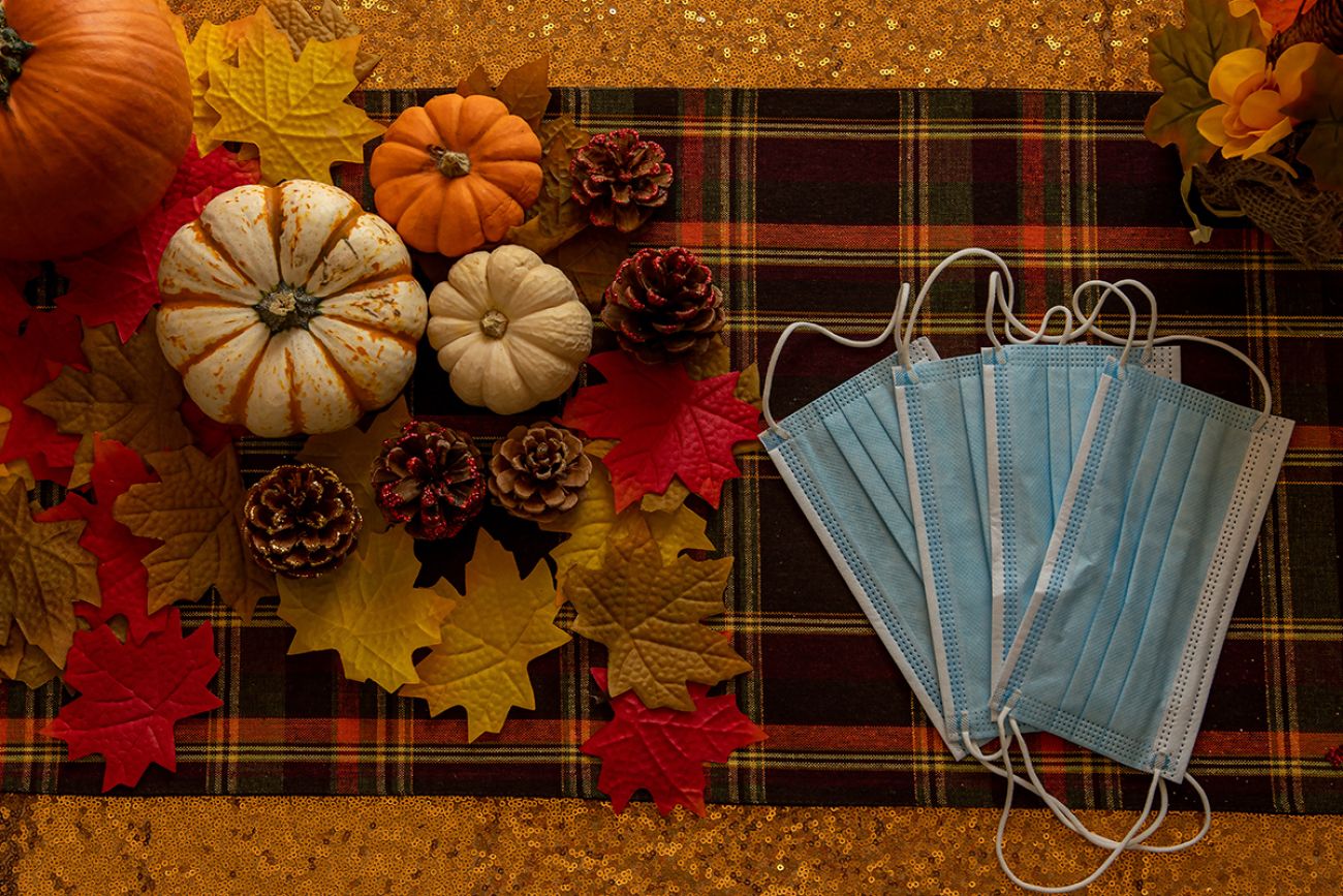 COVID Thanksgiving celebration with masks and pumpkins