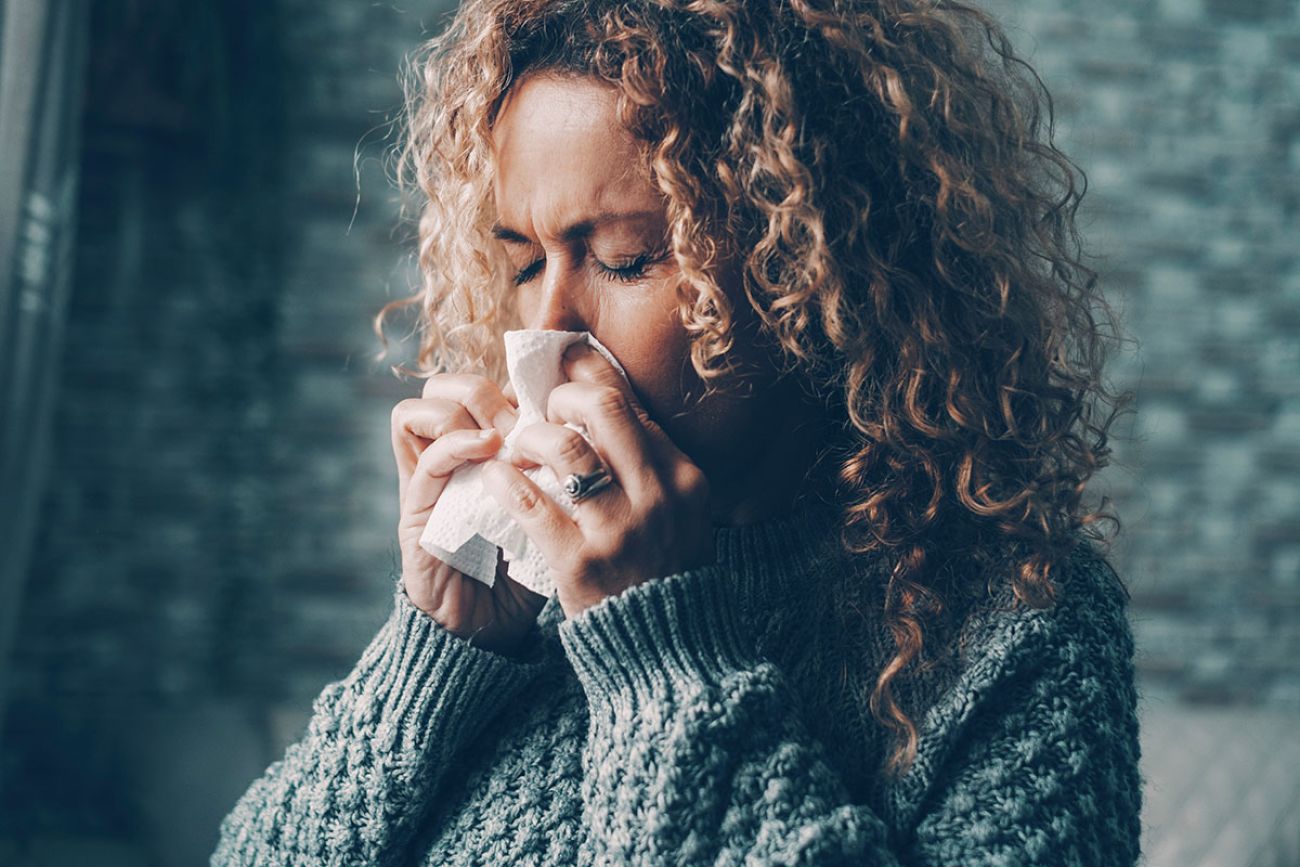 woman sneezing