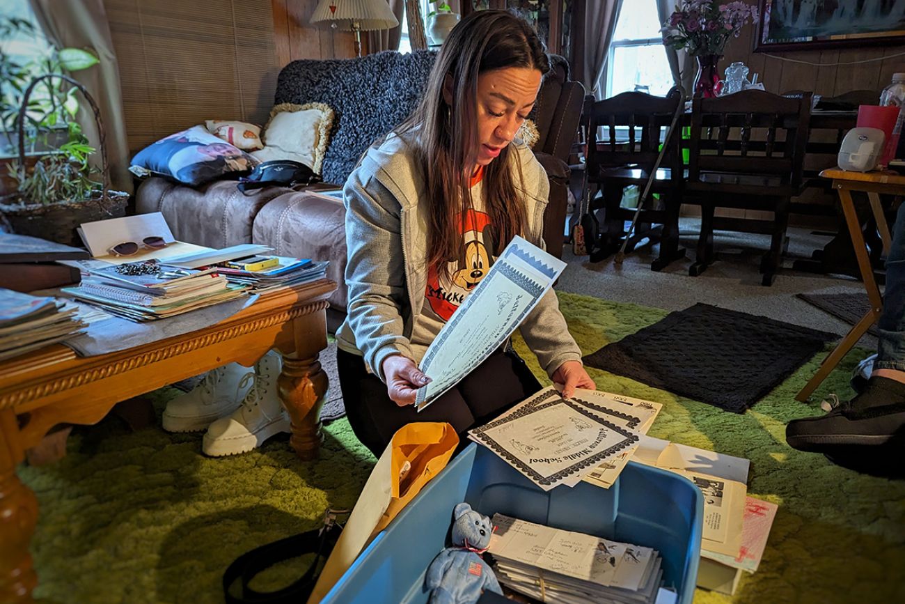 woman looking through items in a box