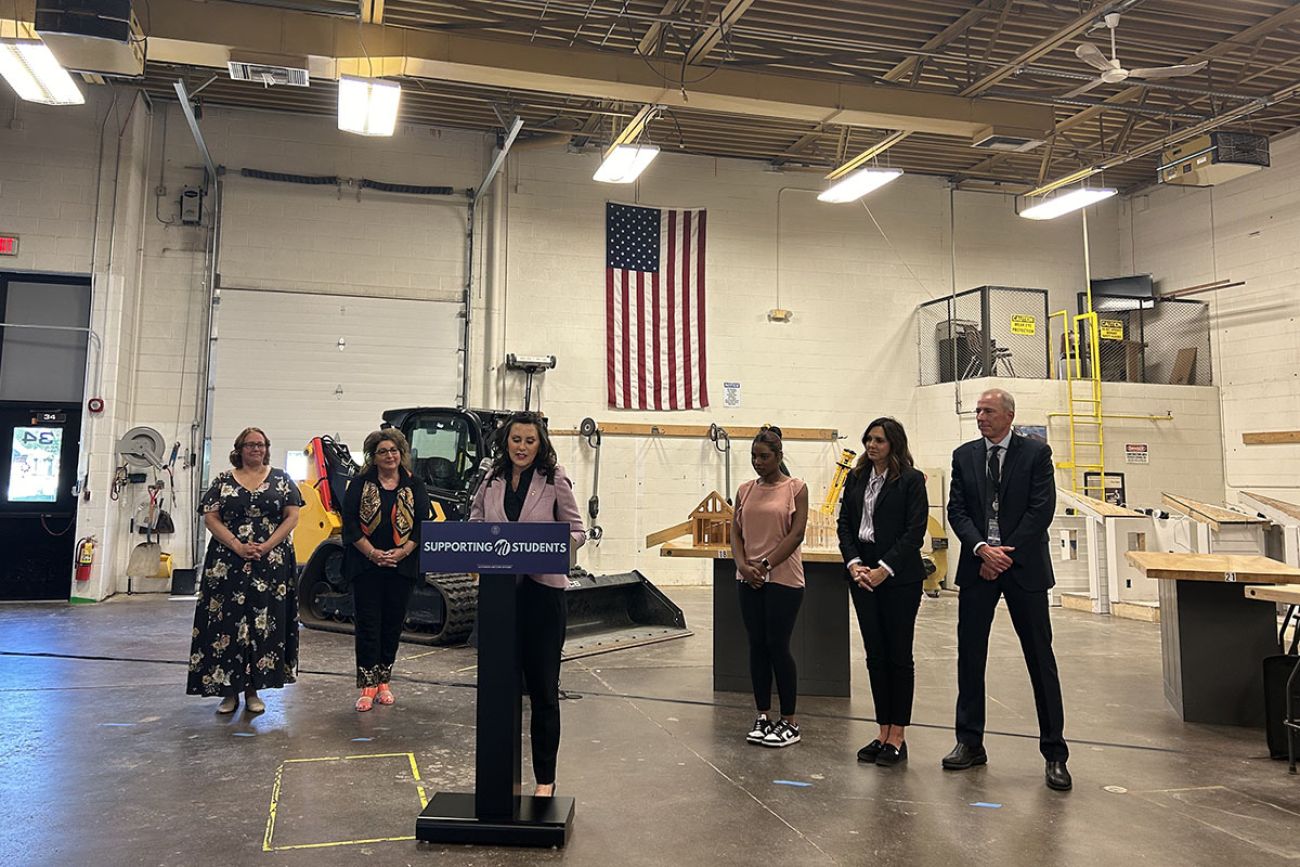 Gov. Gretchen Whitmer speaking into a microphone