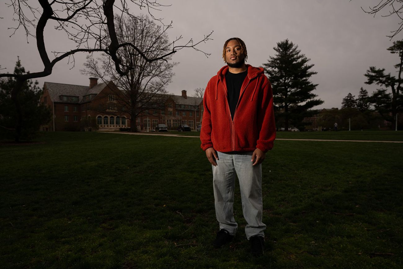 young man with a red hoodie posing for a photo