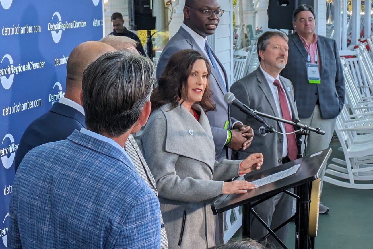 Michigan Gov. Gretchen Whitmer standing next to several people