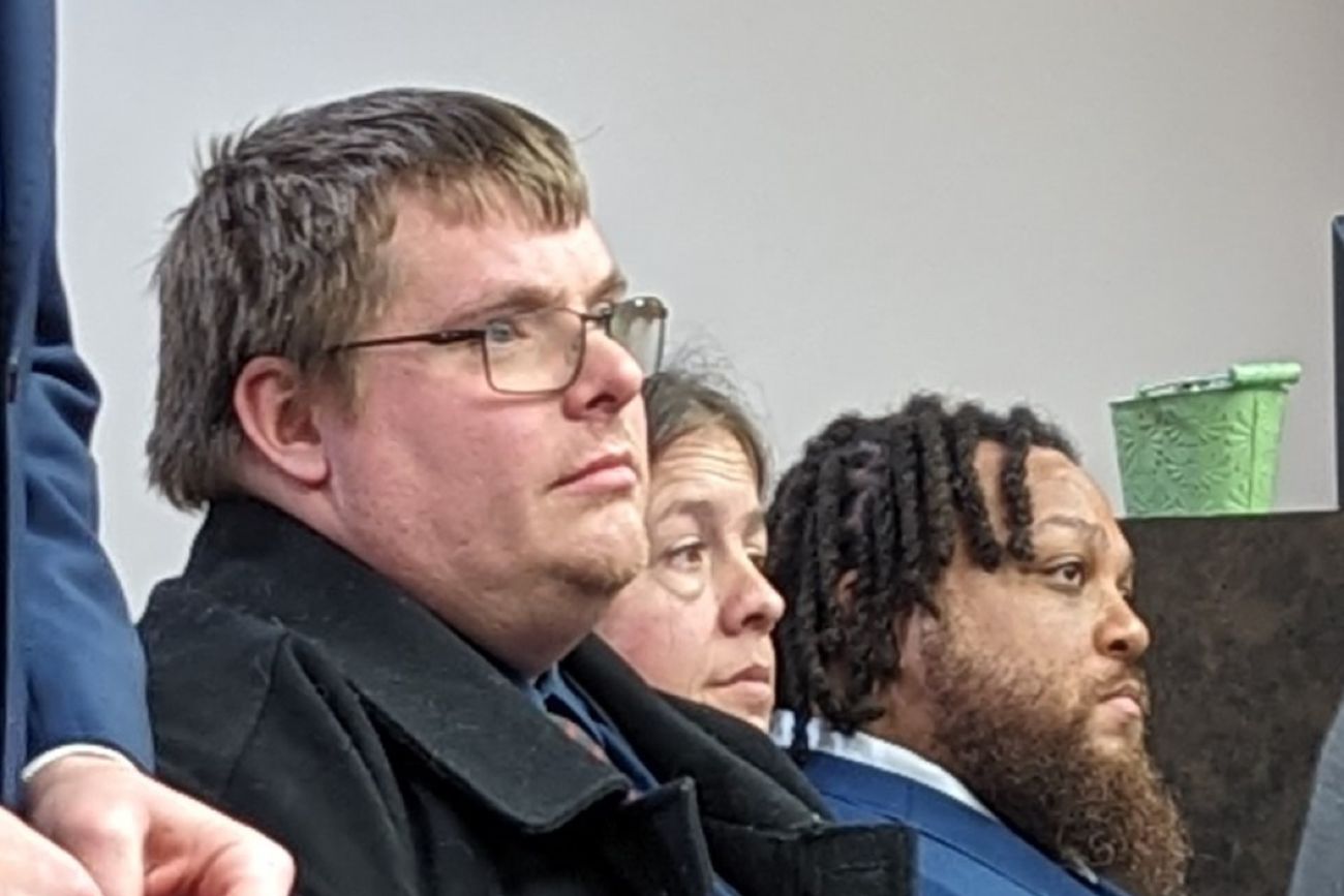 Man sits at a hearing