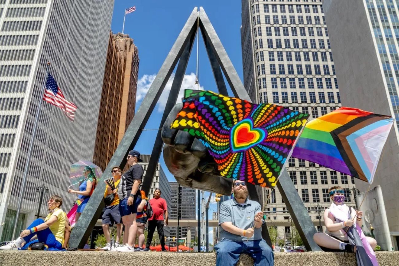 People holding rainbow pride flags in Detroit