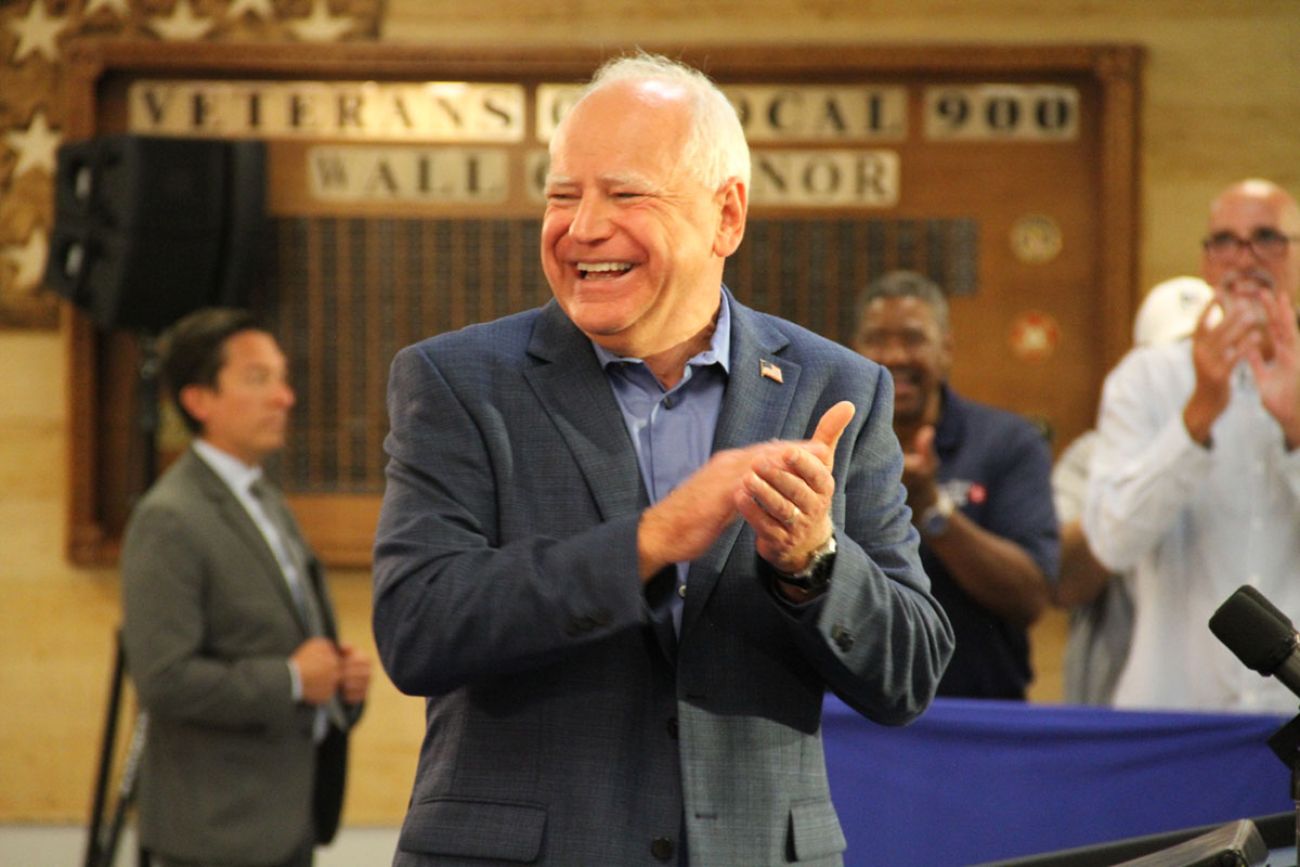 Tim Walz, smiling and hand claping