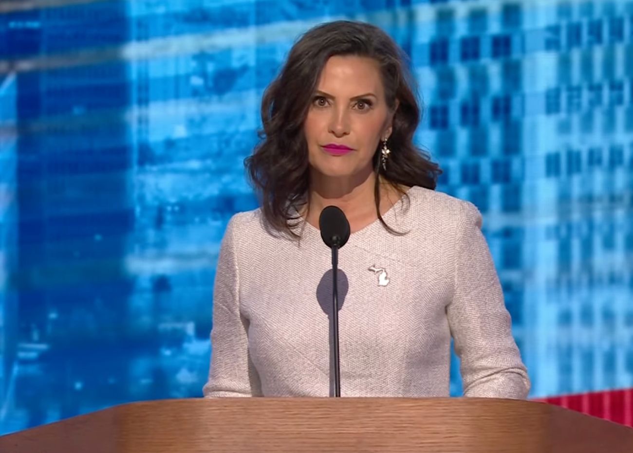 Michigan Gov. Gretchen Whitmer, wearing a white dress, speaks at the DNC in Chicago