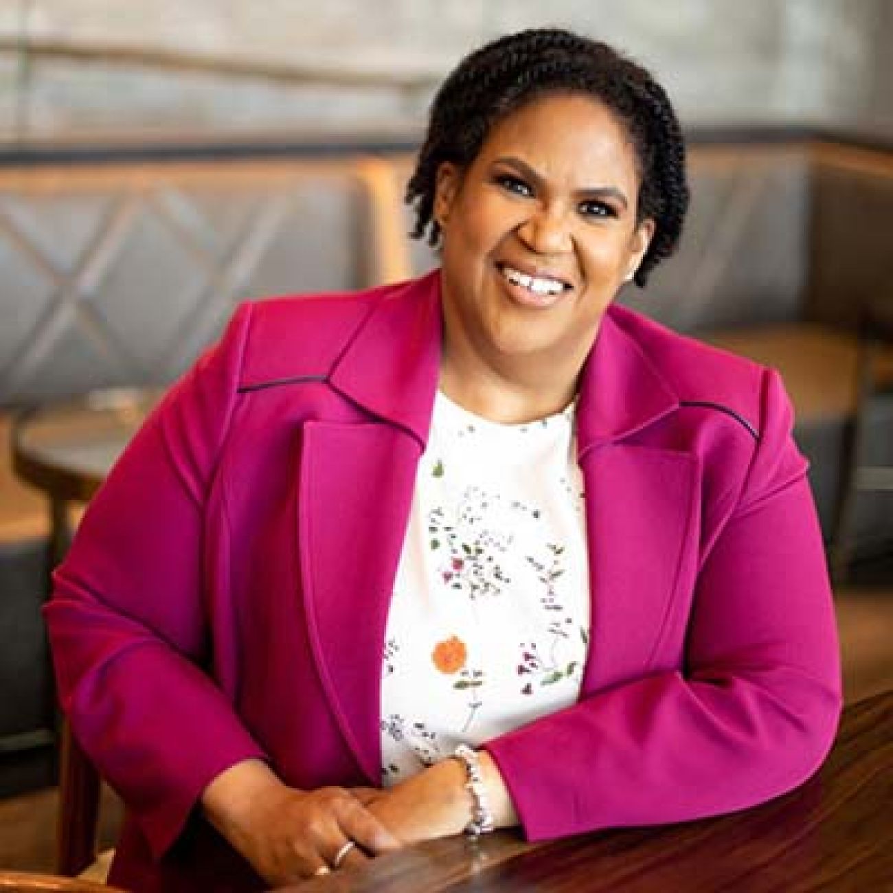 Michigan Democratic Party Chair Lavora Barnes headshot. She is wearing a pink blazer and a shirt with flowers on it