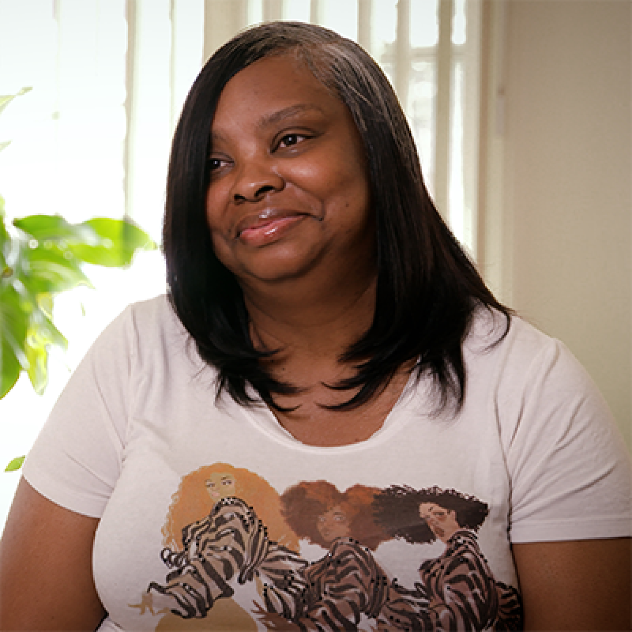 Ravina Turner posing for a picture near a window