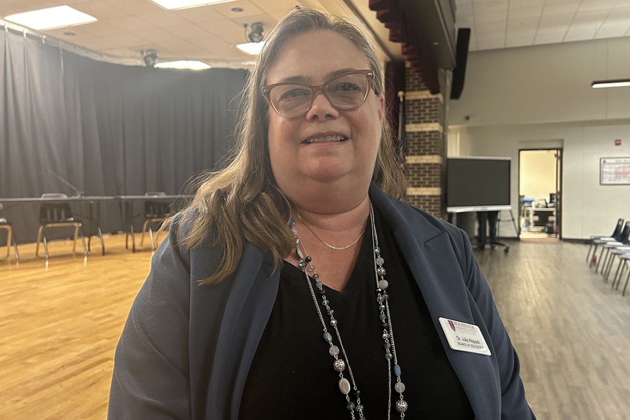 Julie Alspach standing at a school board meeting