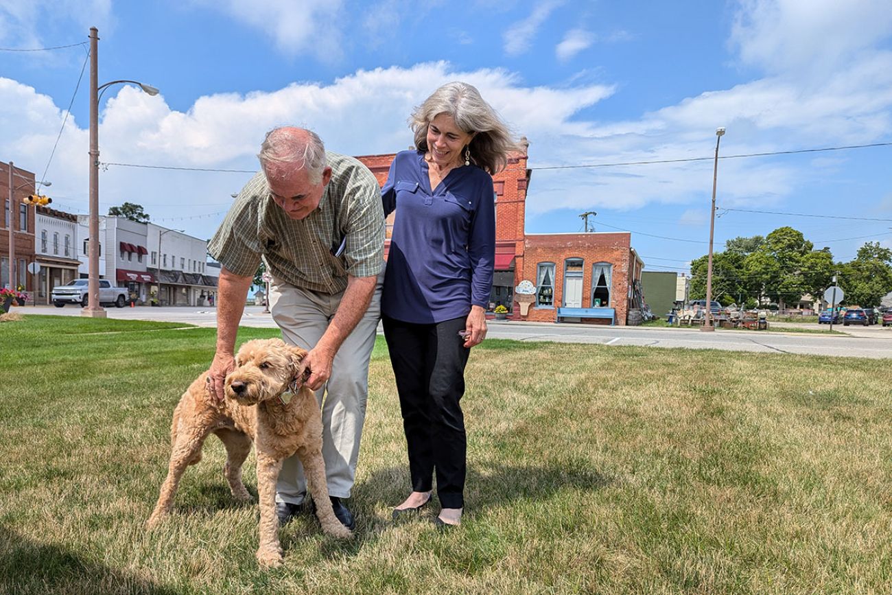 The Canfields standing on grass with their dog