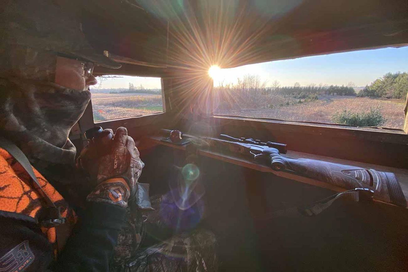 Erik Schnelle, wearing cameo, is sitting in his deer blind