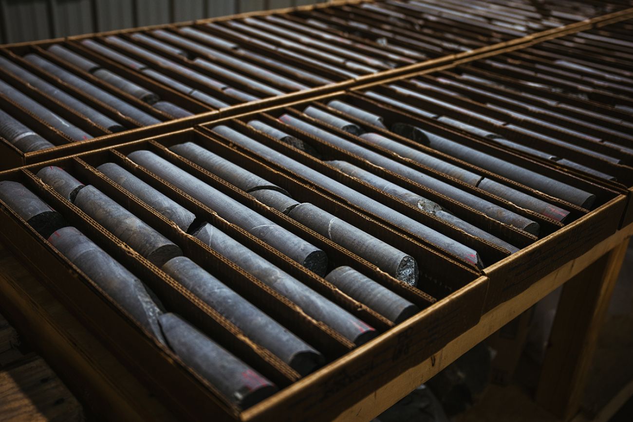 Several rows of rock core samples. They are dark colored and look like a long cylinder