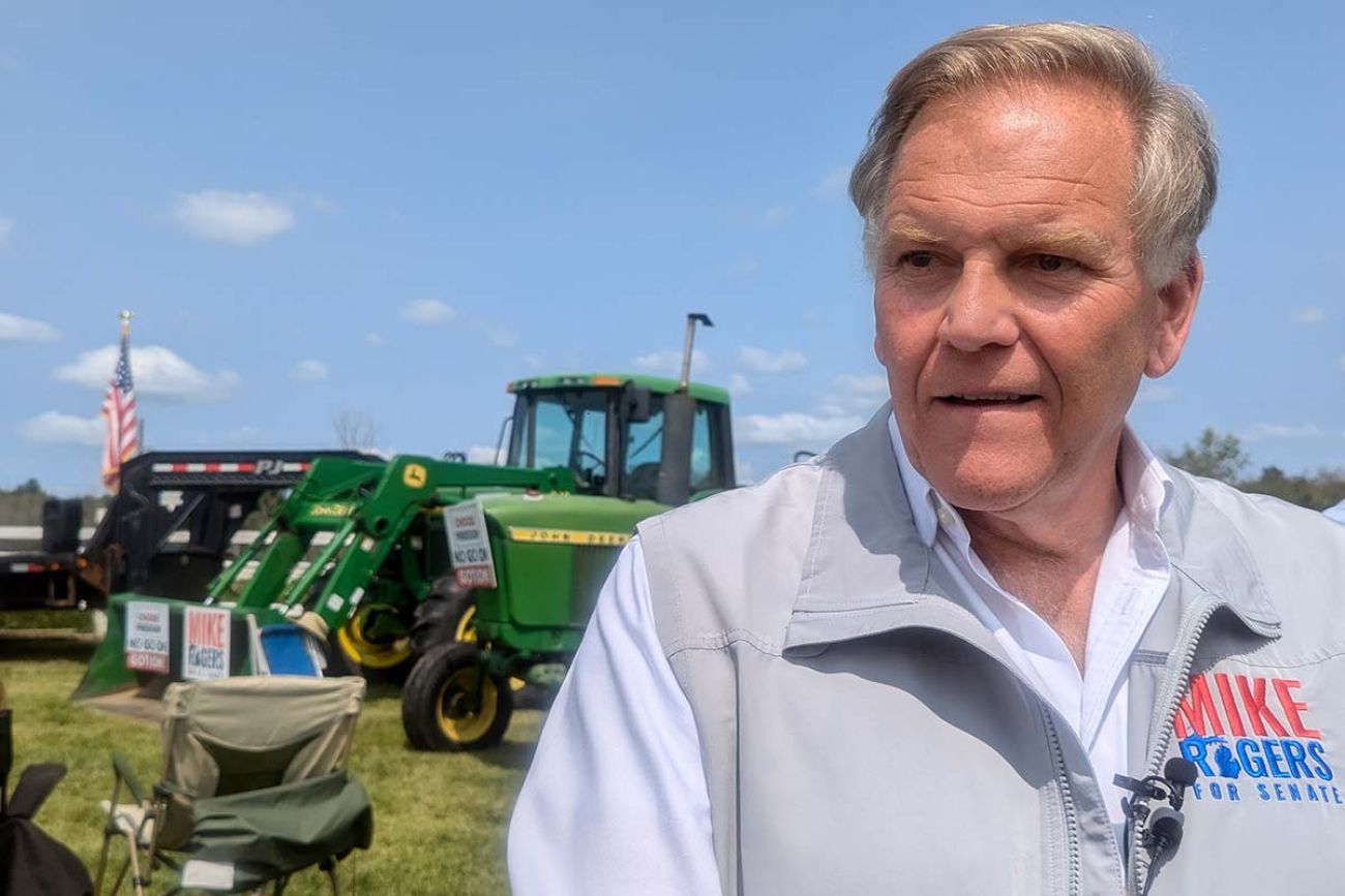 Mike Rogers at a farm, green tractors in the background