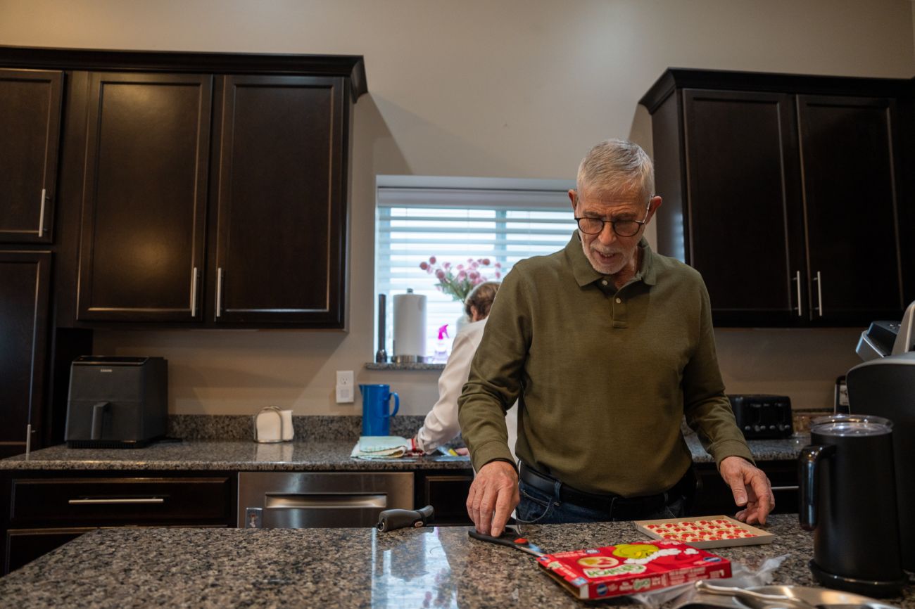 Dr. Arnold Beresh putting cookies on a baking sheet