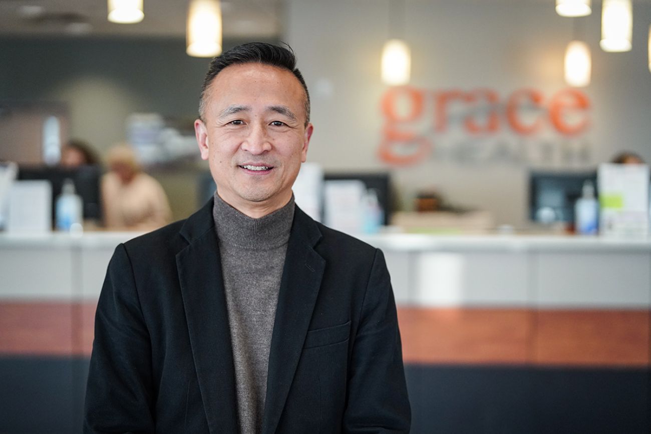 Dr. Peter Chang, wearing a grey turtleneck and black jacket, poses for a photo 