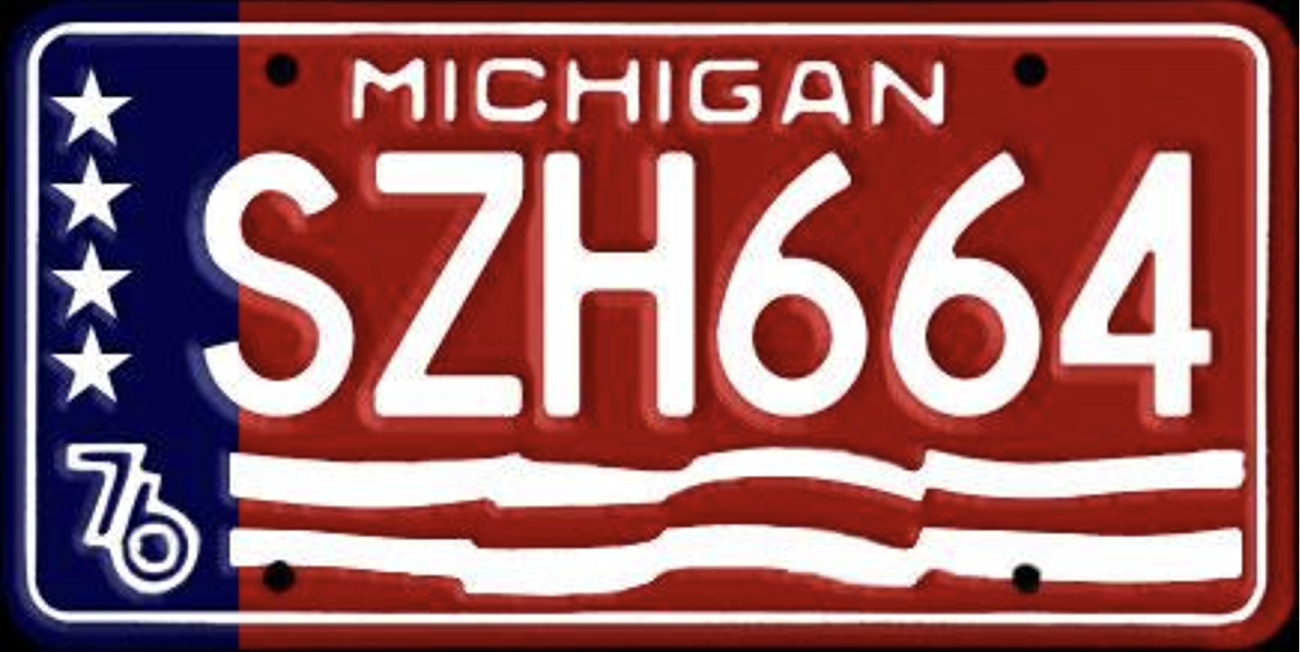 A red, white and blue Michigan license plate. The number 76 is on the left side of the plate