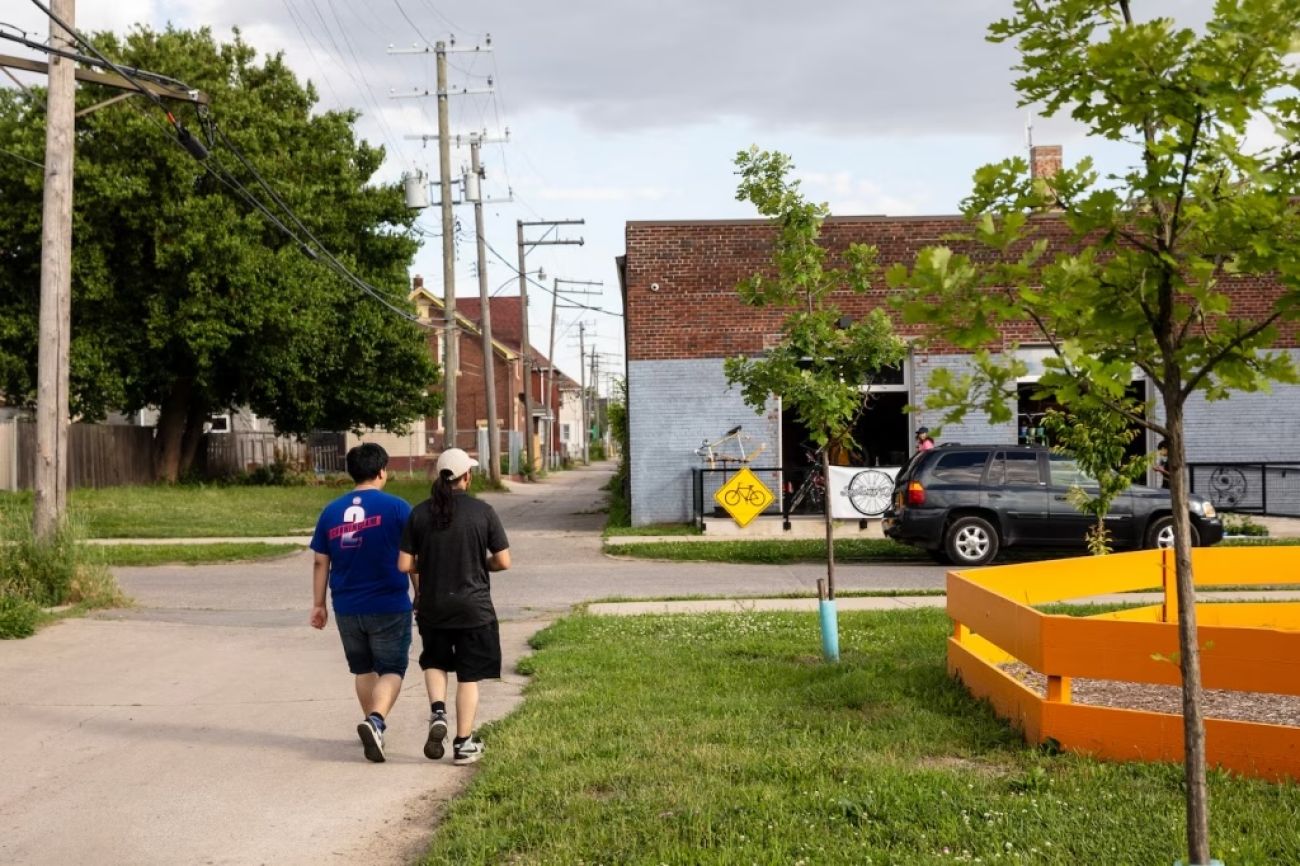 Two people walk outside on a cloudy day