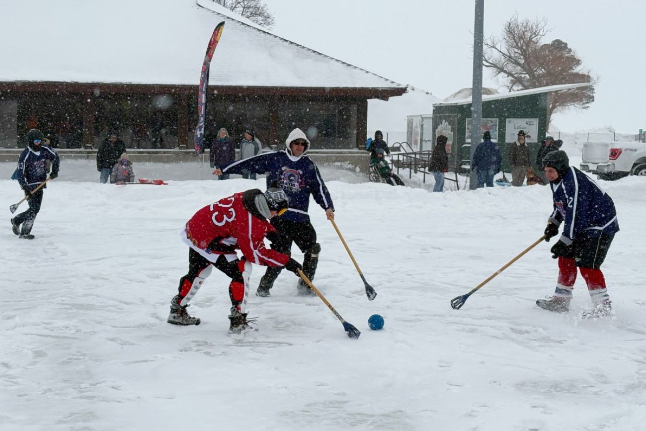 People playing broomball in Alpena, Michigan, on a snowy day.