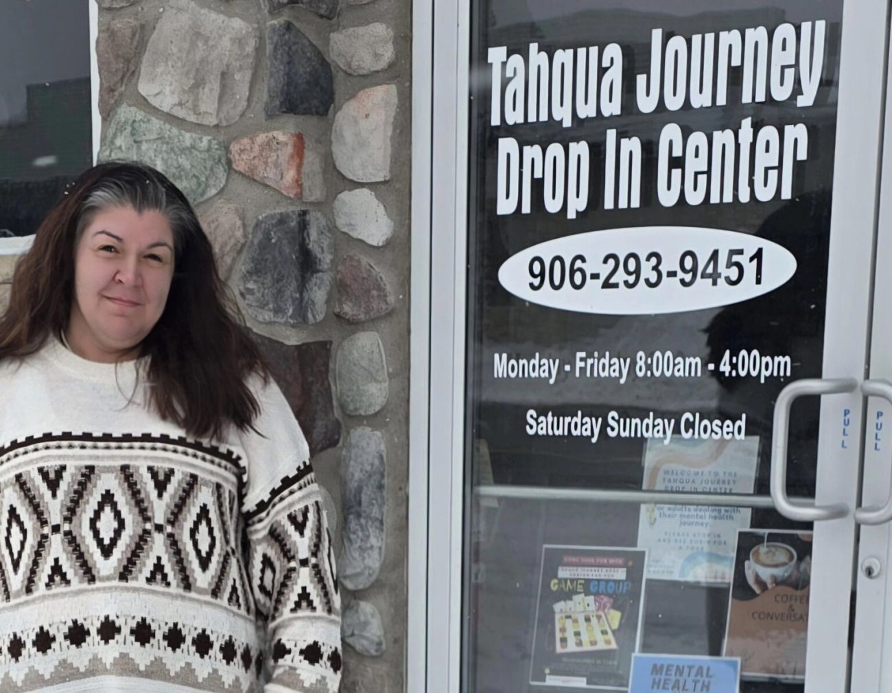 Robin Spindlow stands in front of Tahqua Journey Drop-in Center in Newberry, Michigan.