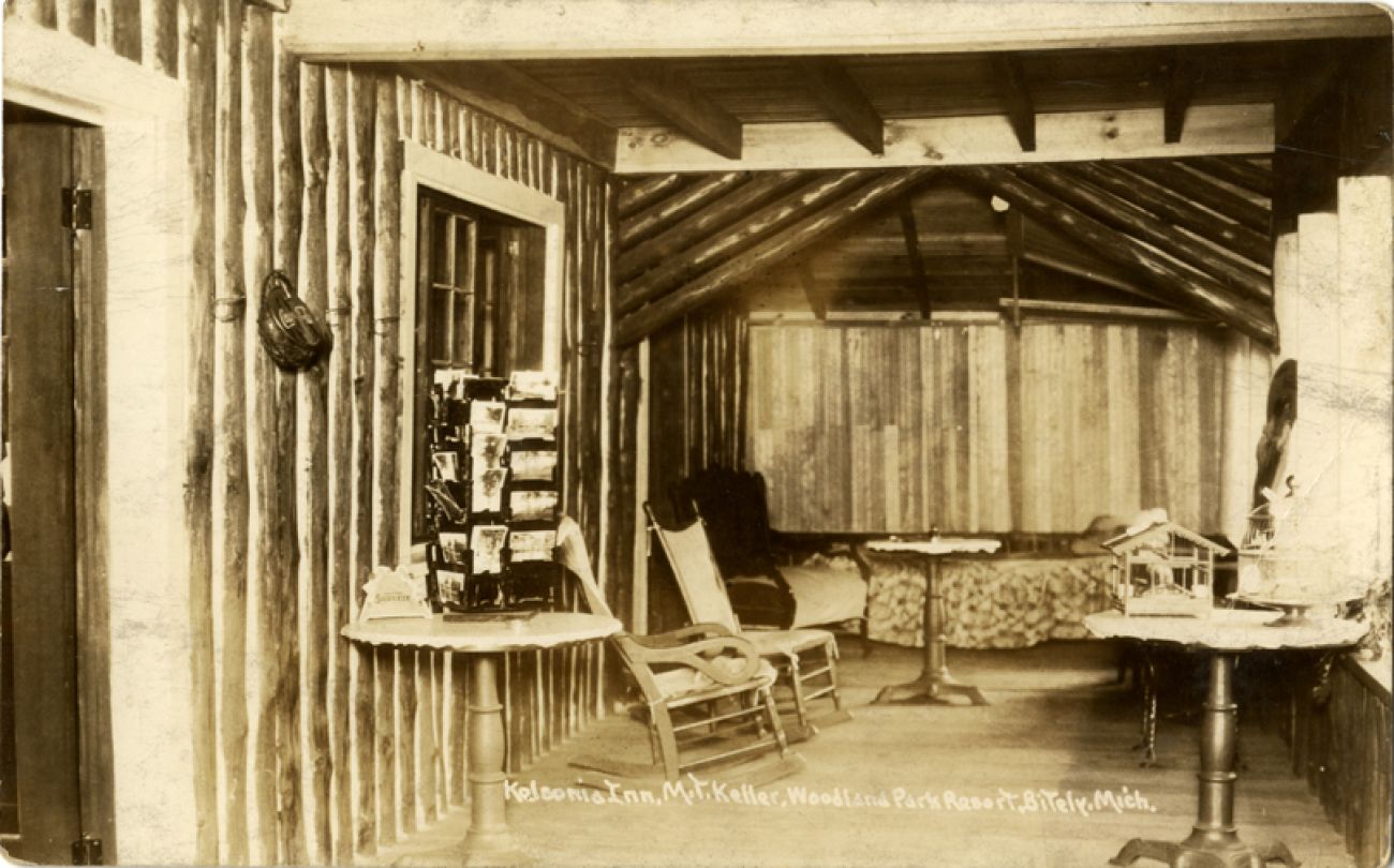 A historic postcard of the Kelsonia Inn. Looks like a small cabin room. 