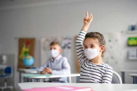 kids in masks in a classroom