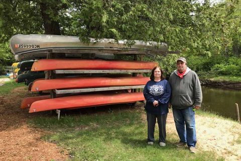 two people by kayaks