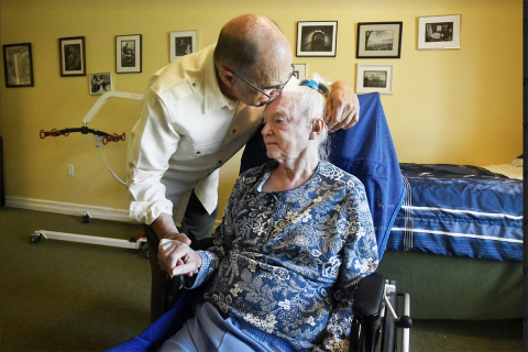 man kissing woman in a wheelchair